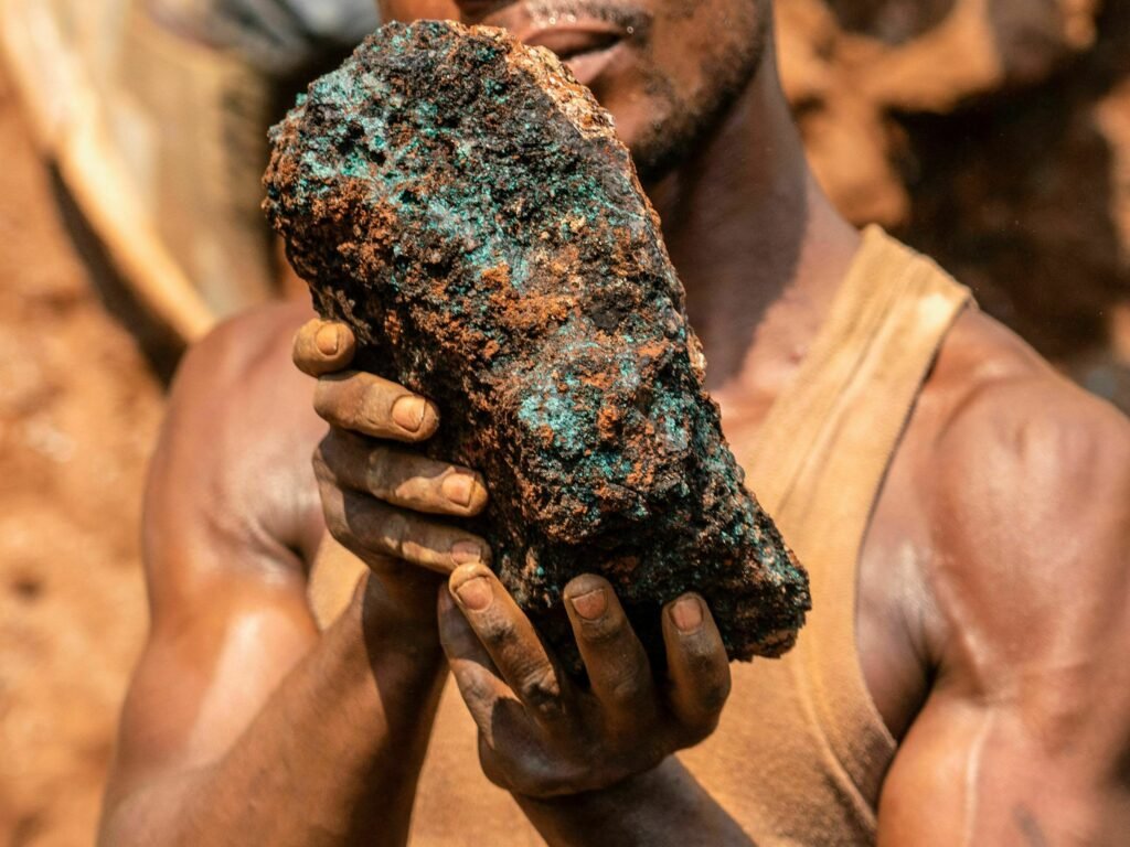 Dela wa Monga, an artisanal miner, holds a cobalt stone at the Shabara artisanal mine near Kolwezi on October 12, 2022. - Some 20,000 people work at Shabara, in shifts of 5,000 at a time.
Congo produced 72 percent of the worlds cobalt last year, according to Darton Commodities. And demand for the metal is exploding due to its use in the rechargeable batteries that power mobile phones and electric cars.
But the countrys poorly regulated artisanal mines, which produce a small but not-negligeable percentage of its total output, have tarnished the image of Congolese cobalt. (Photo by Junior KANNAH / AFP) (Photo by JUNIOR KANNAH/AFP via Getty Images)