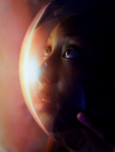 a close up of a person holding a glass