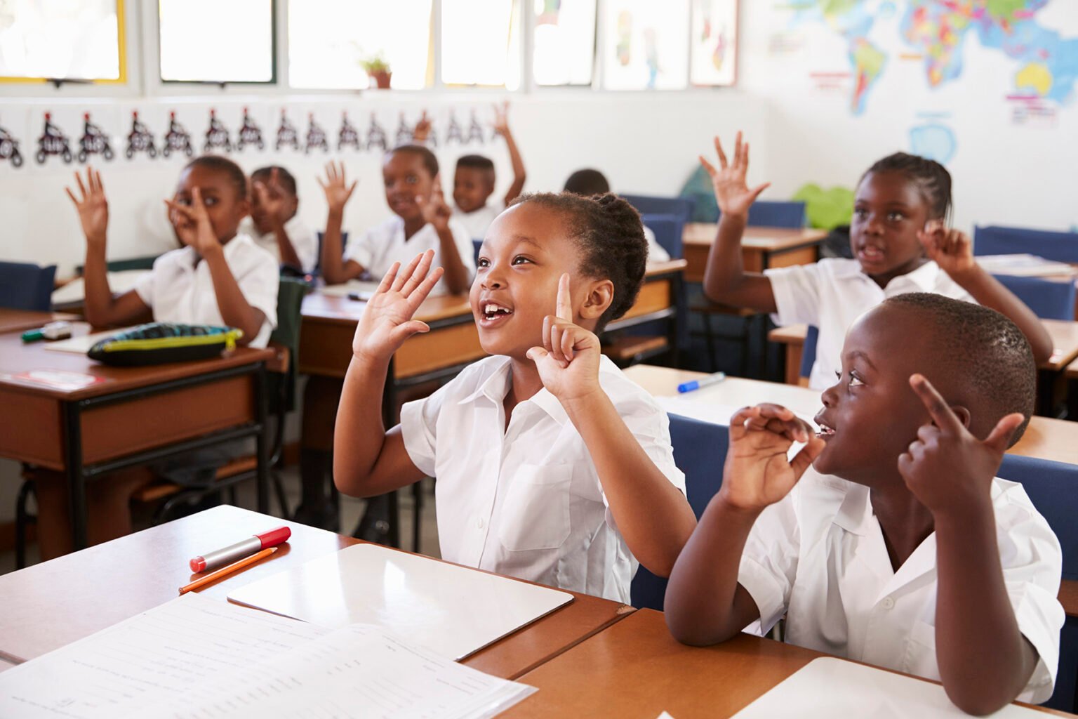 children sitting on chairs inside classroom