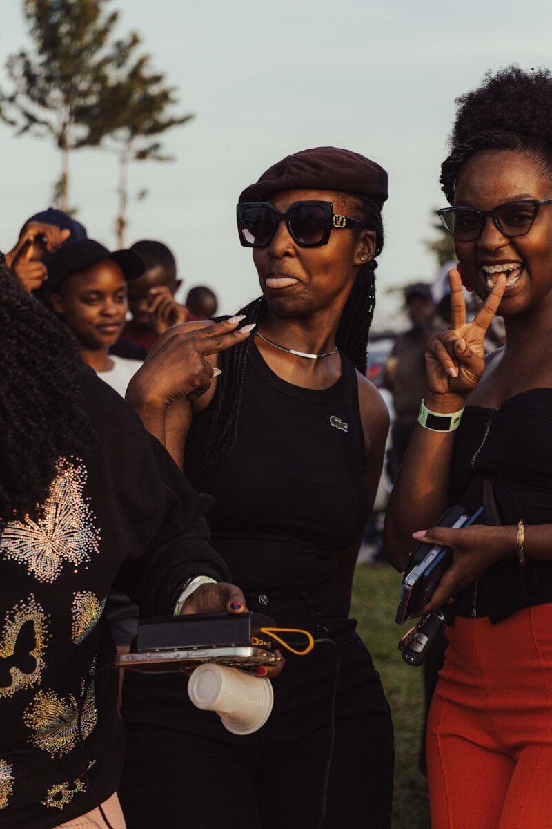 Three young women posing for a fun outdoor gathering