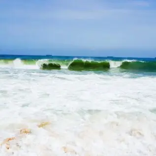 Waves break on Lekki Beach in Lagos, a December 2026 destination for Detty December visitors