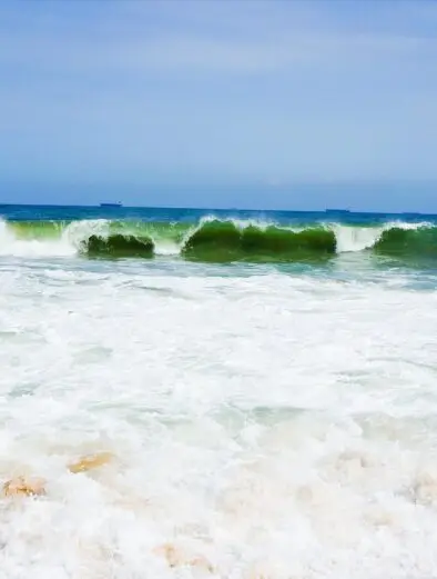 Waves break on Lekki Beach in Lagos, a December 2026 destination for Detty December visitors
