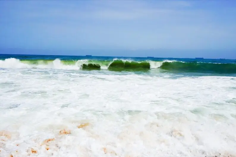 Waves break on Lekki Beach in Lagos, a December 2026 destination for Detty December visitors