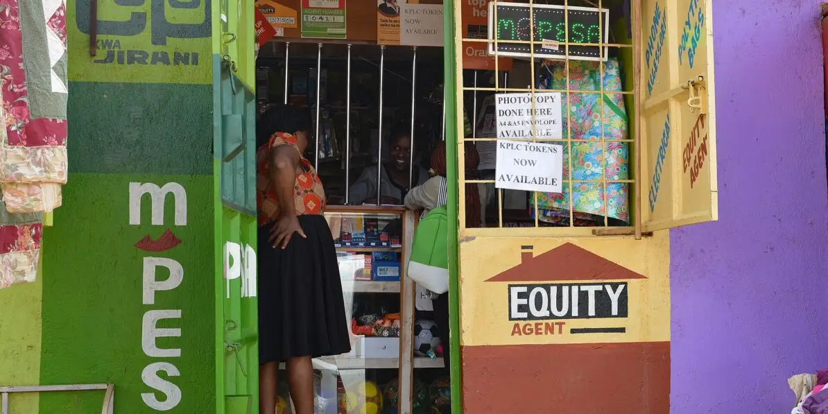 A mobile money agent kiosk in Nairobi where senders and families handle remittance costs