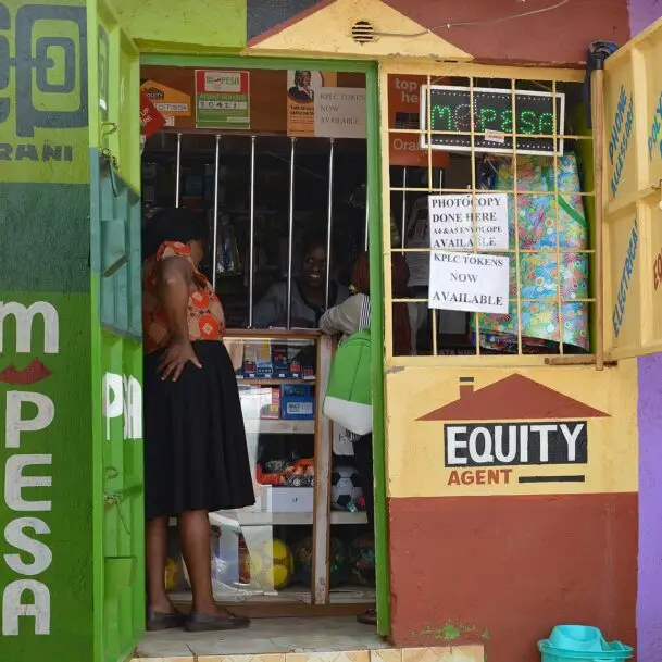 A mobile money agent kiosk in Nairobi where senders and families handle remittance costs