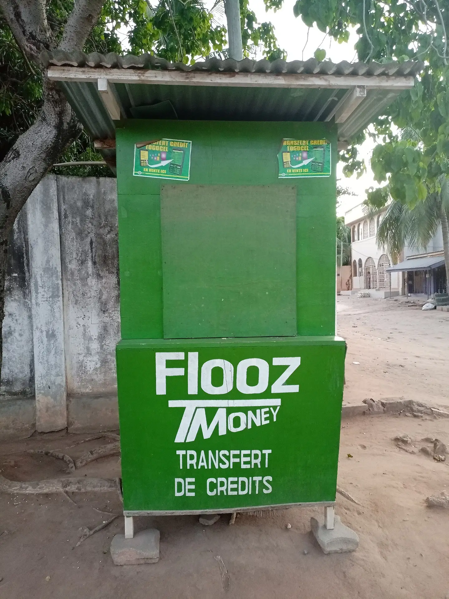 A mobile money kiosk where families collect money sent home