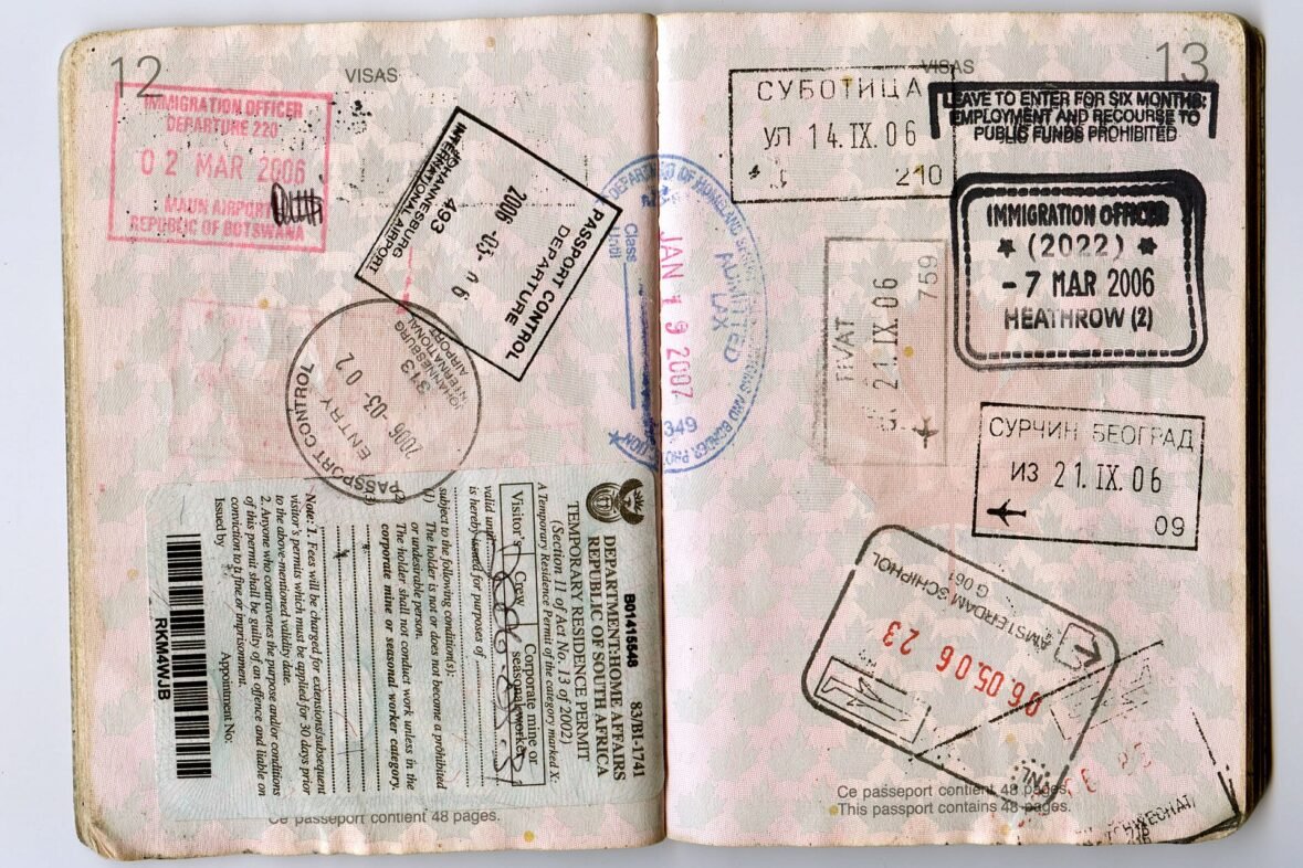 Passport pages with visa and immigration stamps, a reminder to check US entry limits before you apply