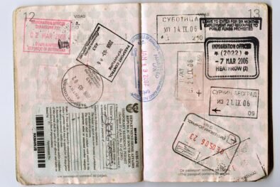 Passport pages with visa and immigration stamps, a reminder to check US entry limits before you apply