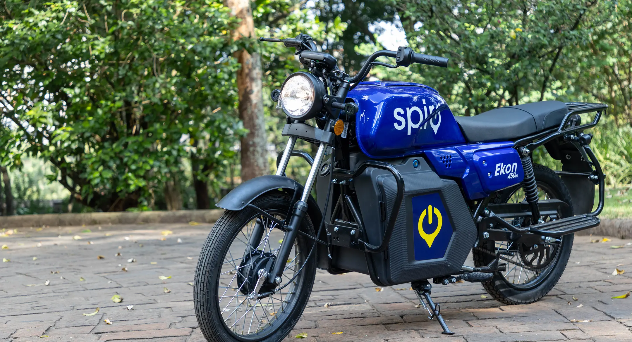 Blue electric motorbike parked on a brick path, the kind of asset behind a startup debt funding deal